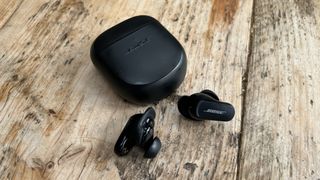 Bose QC Earbuds II displayed on wooden table