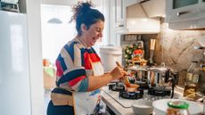 Smiling woman cooking in kitchen